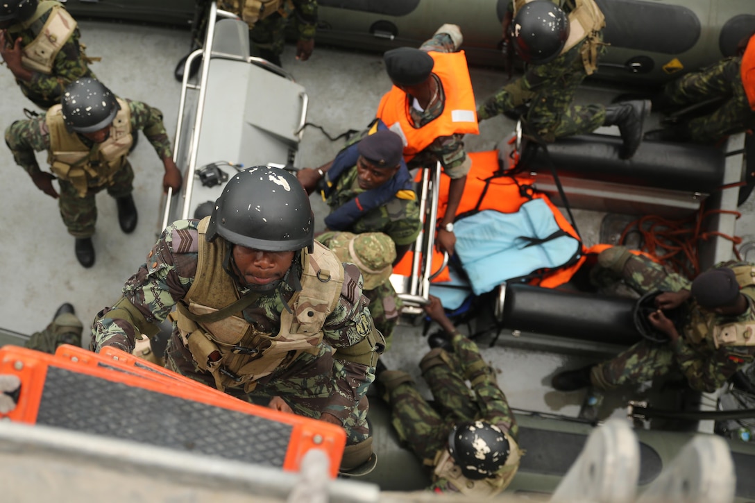 Angolan Marines, also known as Fuzileiros Navais da Marinha de Guerra Angolana (MGA), climb aboard the USNS Spearhead for an engagement in Luanda, Angola, March 4, 2015. U.S. Marines, British Royal Marines and Spanish Marines spent three days working with the Angolans in close-quarters combat, small boat operations and repair, and search and seizure techniques before departing for Cameroon during the maritime security exercise, Africa Partnership Station. (Official U.S. Marine Corps photo by Staff Sgt. Steve Cushman/Released)