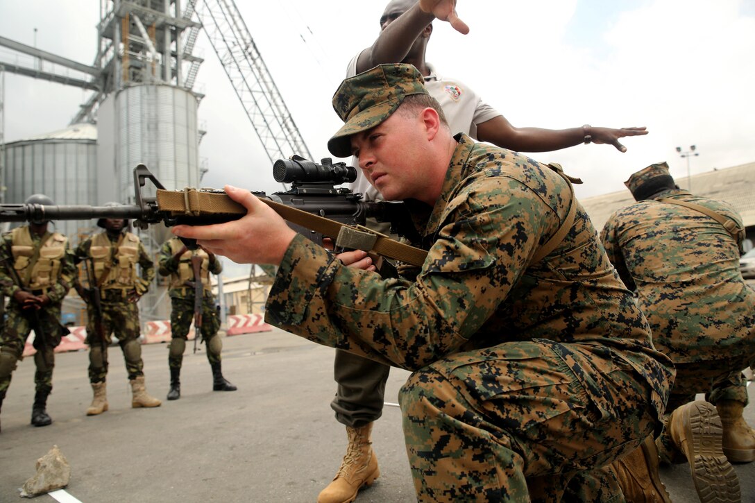 U.S. Marine Cpl. Anthony Bourne, a rifleman with Special-Purpose Marine Air-Ground Task Force Crisis Response-Africa, demonstrates room-clearing techniques to Angolan Marines in Luanda, Angola, March 4, 2015. U.S. Marines, British Royal Marines and Spanish Marines spent three days training with the Angolans in close-quarters combat, small boat operations and repair, and search and seizure techniques before departing for Cameroon during the maritime security exercise, Africa Partnership Station. (Official U.S. Marine Corps photo by Staff Sgt. Steve Cushman/Released)