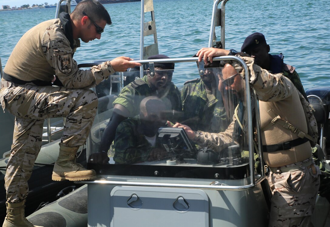 Spanish Marines review navigation equipment with Angolan Marines in Luanda, Angola, March 4, 2015, before conducting coxswain training in the Luanda Harbor. The Spanish Marines worked with the Angolan coxswains on seafaring capabilities. U.S. Marines, British Royal Marines and Spanish Marines spent three days training with the Angolans in close-quarters combat, small boat operations and repair, and search and seizure techniques before departing for Cameroon during the maritime security exercise, Africa Partnership Station. (Official U.S. Marine Corps photo by Staff Sgt. Steve Cushman/Released)