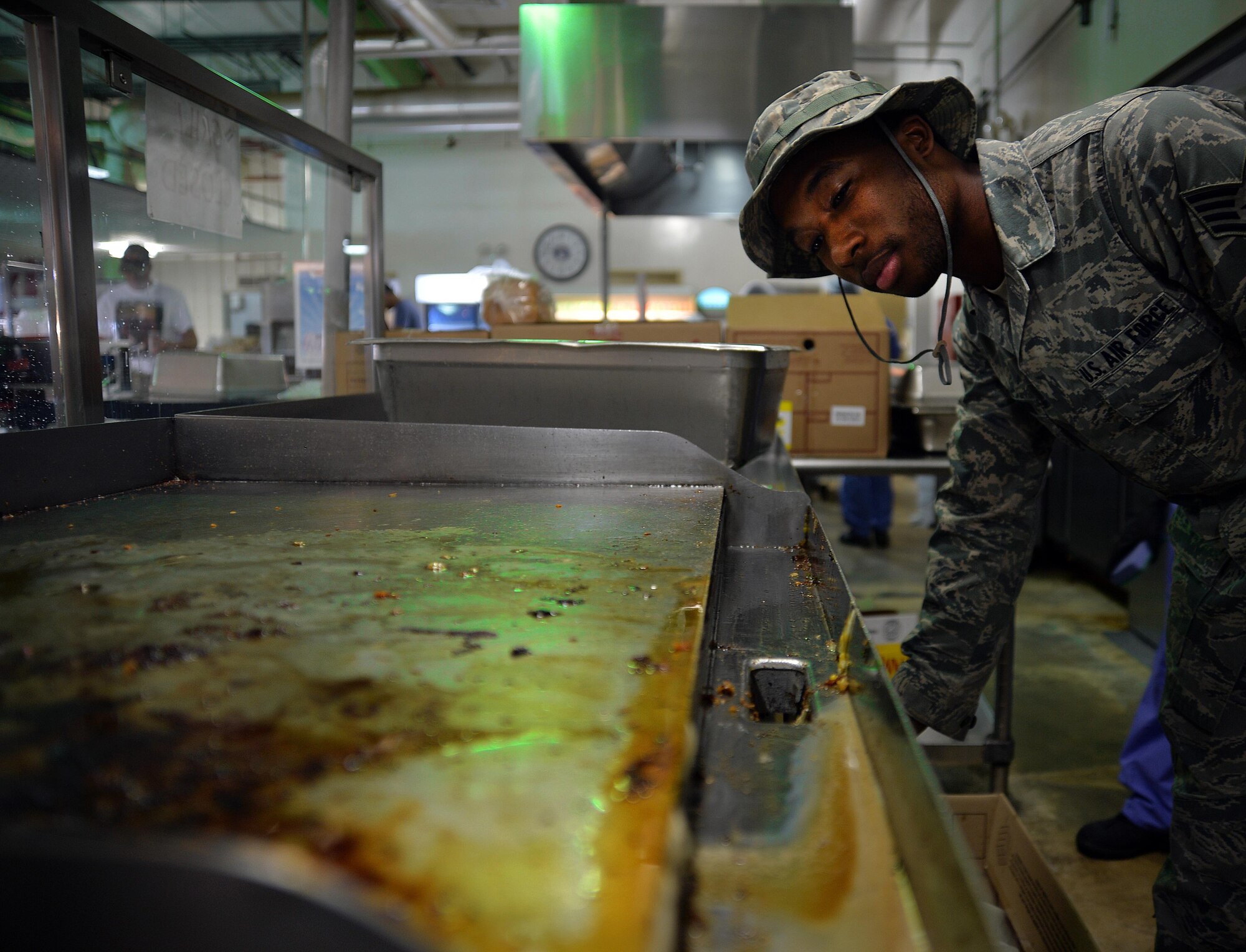 Staff Sgt. Demetrius, public health technician, inspects the dining facility at an undisclosed location in Southwest Asia April 24, 2015. The public health team is responsible for ensuring kitchen equipment is properly cleaned after use and food storage units are up to standard. (U.S. Air Force photo/Tech. Sgt. Jeff Andrejcik)