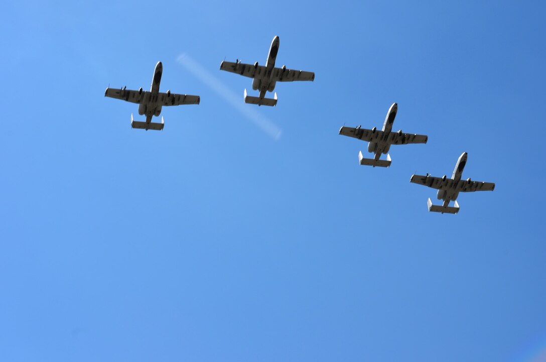 Four A-10 Thunderbolt’s with the 303rd Fighter Squadron, Whiteman Air Force Base, Missouri, perform a fly-over for Capt. Kyle Babbit, 303d Fighter Squadron A-10 Thunderbolt II pilot, at the Air Force Academy May 1. Babbit received The Jabara Award for Airmanship for his selfless actions while deployed downrange September 2013 – October 2014. (U.S. Air Force photo by Capt. Denise Haeussler)
