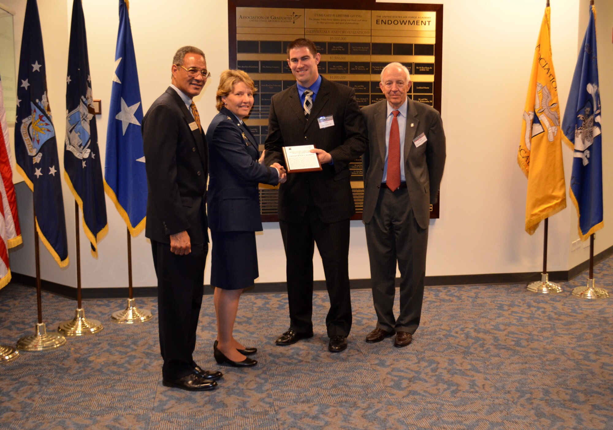 Capt. Kyle Babbit, 303d Fighter Squadron A-10 Thunderbolt II pilot, accepts the Jabara Award for Airmanship from Lt. Gen. Michelle D. Johnson, U.S. Air Force Academy Superintendent May 1. Babbitt earned this award for his hard work and dedication down range between September 2013 and October 2014. (U.S. Air Force photo by Capt. Denise Haeussler)
