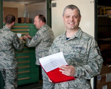 U.S. Air Force Master Sgt. Jon Brownell poses for a photo while evaluating the performance of Airmen in the Logistics Readiness Squadron building a bench stock kit for an F-16 at the 158th Fighter Wing, South Burlington, Vt., April 17, 2015. Brownell has been in Quality Assurance for two years and a Green Mountain Boy for over 23. 