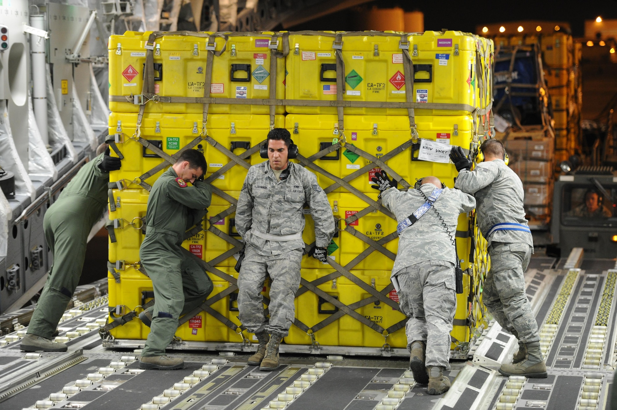 Airmen from March Air Reserve Base, Calif., and Joint Base Charleston, S.C., reposition a pallet of cargo on a C-17 Globemaster III aircraft at March ARB, Calif., April 26, 2015. The equipment includes sonar detection devices, heavy concrete cutting equipment, generators and more that will be used by an elite 57-person team, known as the Urban Search and Rescue Task Force 2 (CA-TF2), in support of earthquake emergency rescue operations in Nepal.

(U.S. Air Force photo/Senior Airman Russell S. McMillan)
