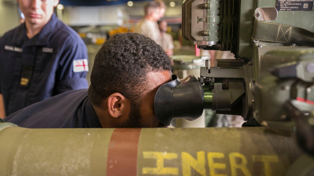 British Royal Navy Able Seaman Ratu Rodelana, logistics steward with the HMS Lancaster, looks through the scope of an M40A5 sniper rifle during a tour aboard the amphibious assault ship USS Wasp (LHD 1) while out at sea April 30, 2015. U.S. Marines and U.S. Navy sailors with the 22nd Marine Expeditionary Unit from Marine Corps Base Camp Lejeune, North Carolina, participated in Navy Week 2015 in New Orleans April 23-29 and Fleet Week Port Everglades, Fla., May 4-10. The purpose of Navy Week was to showcase the strength and capabilities of the Navy-Marine Corps team through tours, static displays and community relations events, providing the public the opportunity to meet and interact with Marines and sailors. (U.S. Marine Corps photo by Sgt. James R. Smith/Released)
