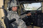 U.S. Army Spc. Martin Jackson, a South Carolina National Guard member who drives for the Paktika Provincial Reconstruction Team, pauses to receive last-minute instructions prior to driving his mine resistant ambush protected vehicle on a recent mission at Forward Operating Base Sharana Oct. 15, 2010. Jackson, an 18-year Army veteran, is a long-haul trucker when not activated with his unit. On the PRT, Jackson not only serves as a driver, but also volunteers his free time to maintain the vehicles and ensure they are mission-capable each day.