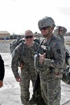 U.S. Army Maj. John L. Davis, leader of Texas Agribusiness Development Team-IV, greets Maj. William R. Davis, Leader of Texas ADT-III as he assists him to the aircraft. Texas ADT-IV replaced Texas ADT-III at Forward Operating Base Ghazni in Southeast Afghanistan, Oct 13, 2010.