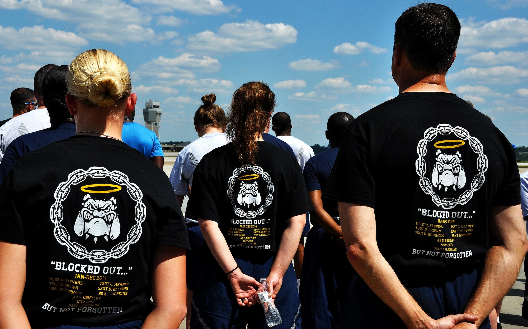 Members of Dobbins Air Reserve Base stand in formation during the Port Dawg Memorial Run on Dobbins ARB, Ga., May 3, 2015.  Air transportation Airmen from the 94th Aerial Port Squadron, as well as members from other base units, participated in the run honoring fallen Airmen from their career field. The run was part of a coordinated event with other air transportation units from across the globe holding similar memorial runs. (U.S. Air Force photo/Senior Airman Daniel Phelps)