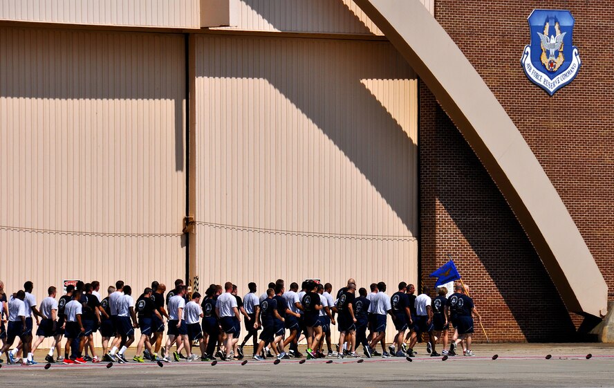 Members of Dobbins Air Reserve Base run along the flightline during the Port Dawg Memorial Run on Dobbins ARB, Ga., May 3, 2015.  Air transportation Airmen from the 94th Aerial Port Squadron, as well as members from other base units, participated in the run honoring fallen Airmen from their career field. The run was part of a coordinated event with other air transportation units from across the globe holding similar memorial runs. (U.S. Air Force photo/Senior Airman Daniel Phelps)