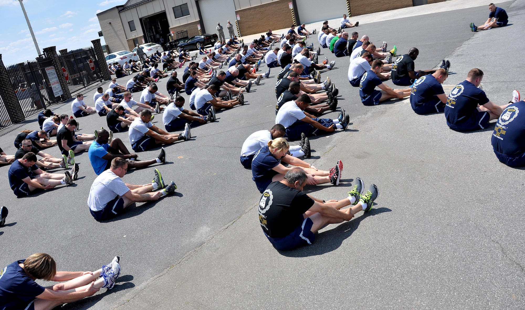 Members of Dobbins Air Reserve Base stretch near the Aerial Port Squadron before the Port Dawg Memorial Run on Dobbins ARB, Ga., May 3, 2015.  Air transportation Airmen from the 94th Aerial Port Squadron, as well as members from other base units, participated in the run honoring fallen Airmen from their career field. The run was part of a coordinated event with other air transportation units from across the globe holding similar memorial runs. (U.S. Air Force photo/Senior Airman Daniel Phelps)
