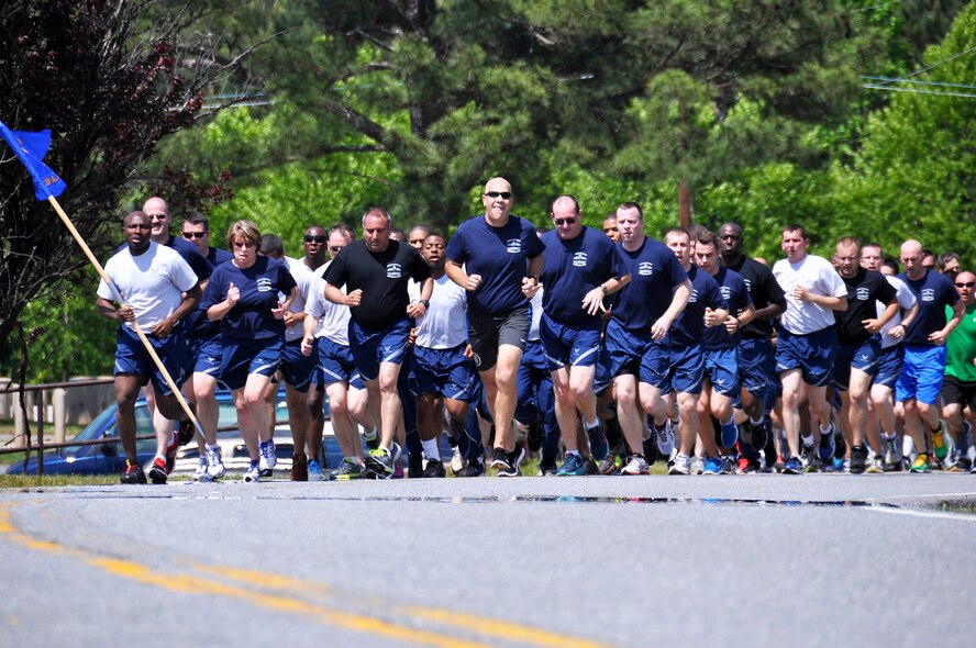 Members of Dobbins Air Reserve Base run up a hill during the Port Dawg Memorial Run on Dobbins ARB, Ga., May 3, 2015.  Air transportation Airmen from the 94th Aerial Port Squadron, as well as members from other base units, participated in the run honoring fallen Airmen from their career field. The run was part of a coordinated event with other air transportation units from across the globe holding similar memorial runs. (U.S. Air Force photo/Senior Airman Daniel Phelps)