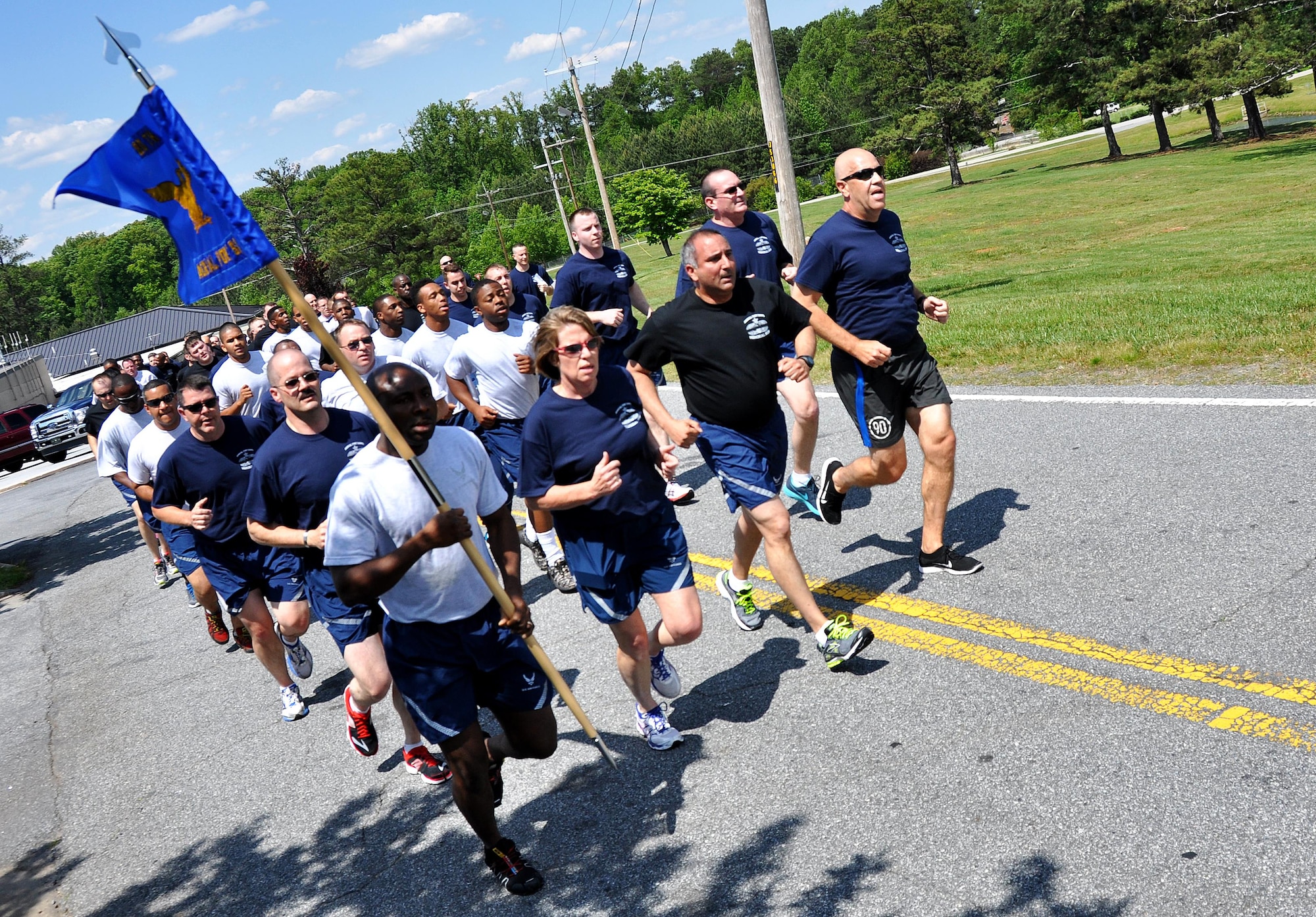 Members of Dobbins Air Reserve Base run up a hill during the Port Dawg Memorial Run on Dobbins ARB, Ga., May 3, 2015.  Air transportation Airmen from the 94th Aerial Port Squadron, as well as members from other base units, participated in the run honoring fallen Airmen from their career field. The run was part of a coordinated event with other air transportation units from across the globe holding similar memorial runs. (U.S. Air Force photo/Senior Airman Daniel Phelps)
