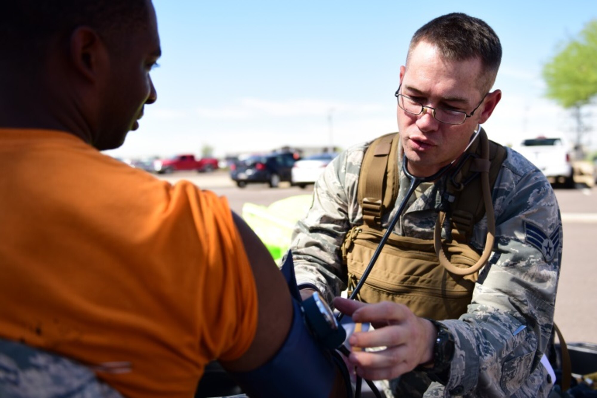 Senior Airman Andrew Plante, 944th Medical Squadron medical technician, checks vitals of a bioenvironmental engineer technician with the 56th Aerospace Medicine Squadron during the "Operation PATRIOT BLUEBIRD" exercise May 1, 2015. As temperatures climbed up to the century mark during the “Operation PATRIOT BLUEBIRD” exercise heat exhaustion became a real factor. Plante and other medical technicians in "non-player" roles were on stand-by to provide real world medical support to help ensure everyone's safety. (U.S. Air Force photo/SSgt Lausanne Kinder)
