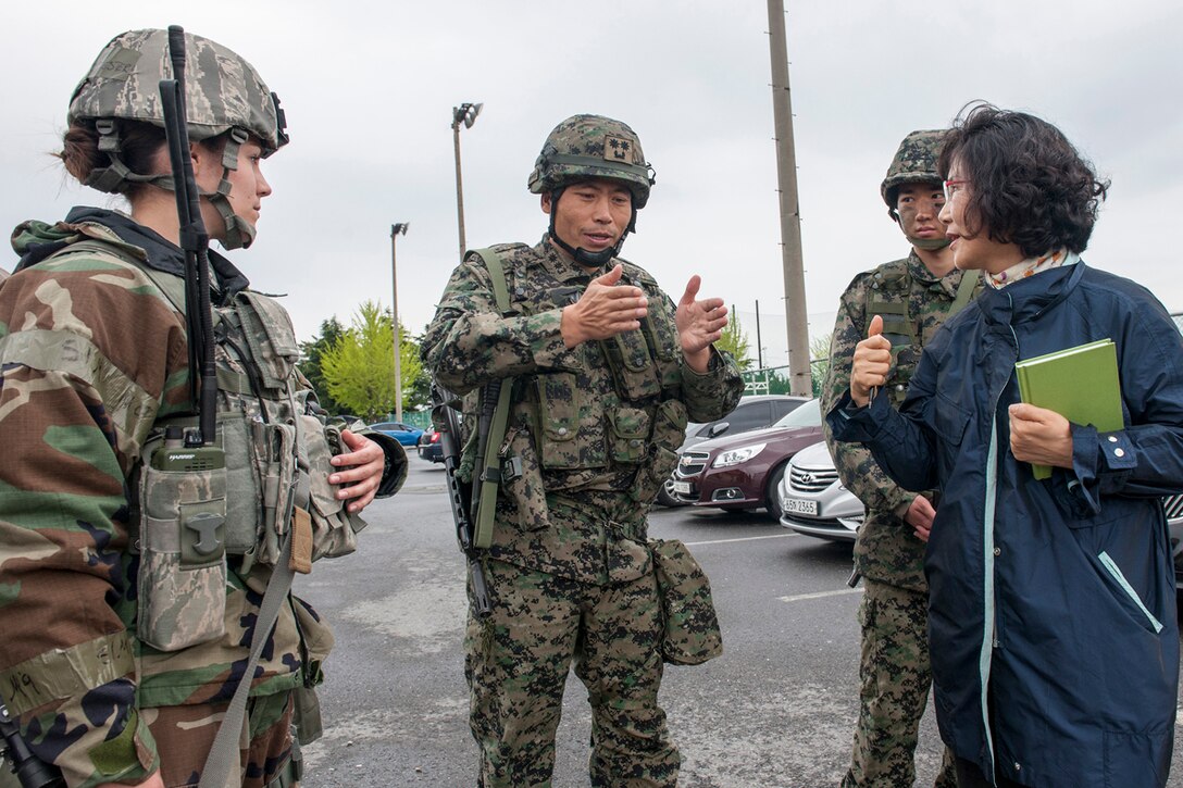 KUNSAN AIR BASE, Republic of Korea (Apr. 29, 2015) - 1st Lt. Tasha Worcester, 8th Security Forces Squadron plans and programs officer (ROKSOF) in charge (left), listens to Lt. Col. Ko Dong Woon, Republic of Korea Special Operations Forces 35th Battalion, 7th Airborne Brigade commander, discuss training scenarios as Chom Suk Yi, 8th SFS liaison officer (right), translates between Korean and English. For the first time in more than seven years, ROKSOF integrated operations with Wolf Pack defenders during a 24-hour exercise held in conjunction with Exercise Beverly Midnight 15-3. (U.S. Air Force photo by Senior Airman Katrina Heikkinen)