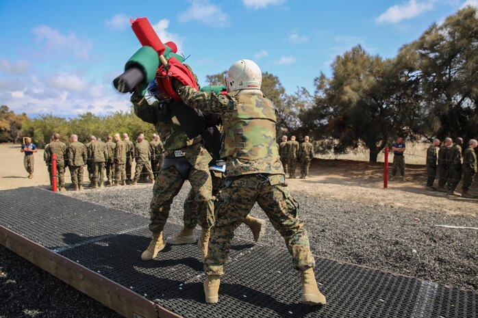 A recruit of Lima Company, 3rd Recruit Training Battalion, blocks a strike from his opponent during a pugil sticks bout at Marine Corps Recruit Depot San Diego, April 23. During each bout recruits are expected to apply the techniques they were just taught. A fighter will become victorious if he is able to deliver a strike to his opponent’s head or force him off of the bridge. Before the battles began, recruits double checked their protective gear because once in the arena, they used full force. Helmets, groin protector, flak jackets, gloves and mouthpieces were given to each recruit. Today, all male recruits recruited from recruiting stations west of the Mississippi are trained at MCRD San Diego. The depot is responsible for training more than 16,000 recruits annually. Lima Company is scheduled to graduate from recruit training on June 19.