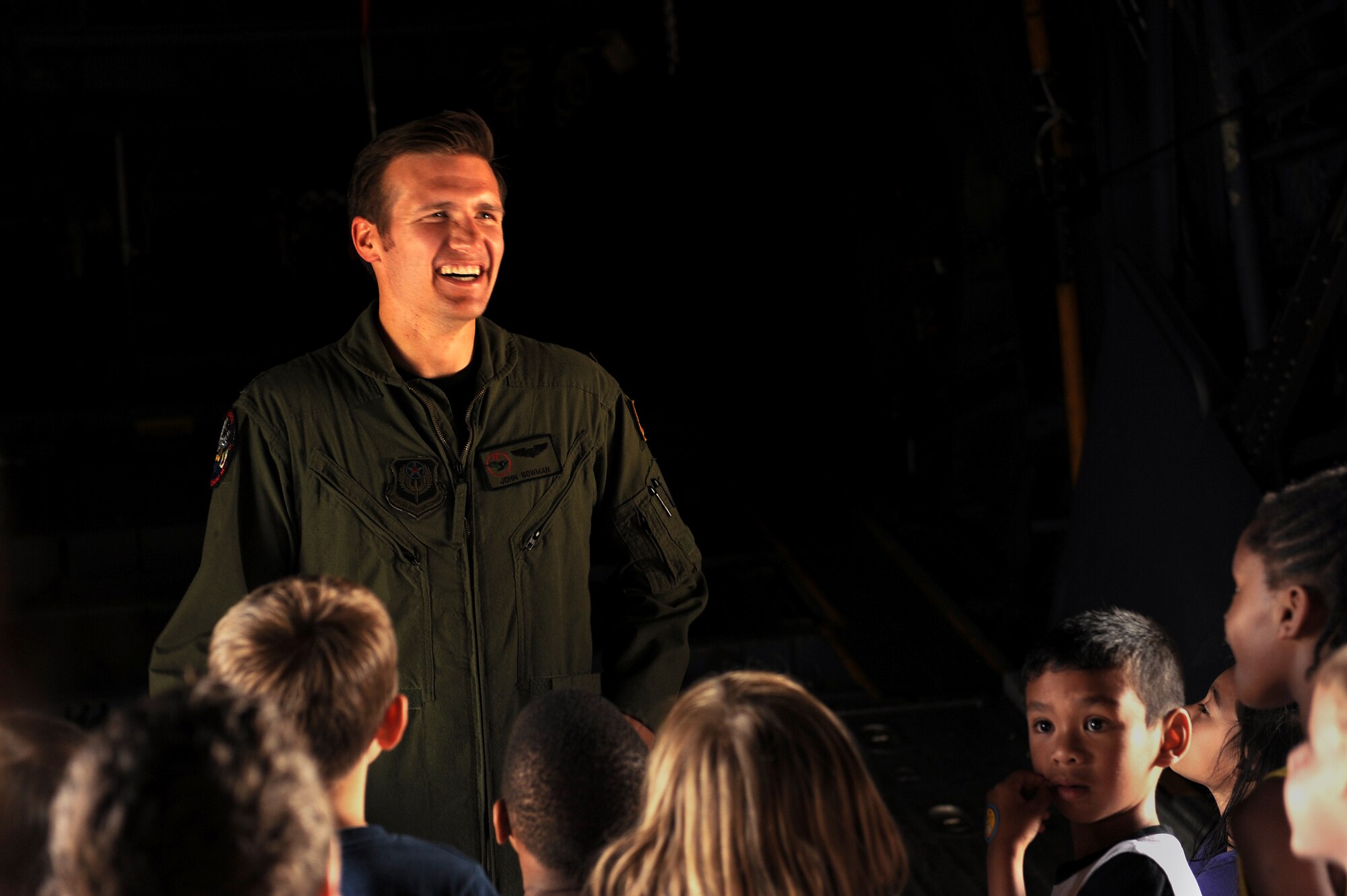 U.S. Air Force Capt. John Bowman, 1st Special Operations Squadron MC-130H Combat Talon II pilot, answers questions from school-age children during a flight line tour on Kadena Air Base, Japan, May 1, 2015. Bowman and other volunteers gave approximately 130 children tours of various aircraft in support of the Month of the Military Child. (U.S. Air Force photo by Airman 1st Class Zade C. Vadnais)