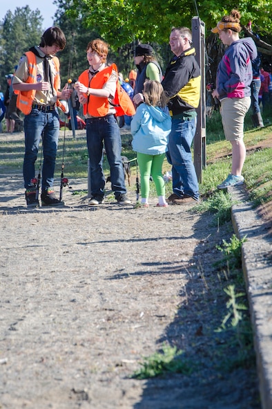 Boy Scouts of America volunteers help Col. Brian McDaniel’s daughter bait her hook during a fishing derby May 2, 2015, at Fairchild Air Force Base’s Clear Lake Resort and Recreation Area, Wash. The fishing derby cost $10 per child and included a T-shirt, fishing pole and three fish gutted and cleaned on-site by Clear Lake personnel and volunteers. The military recreation area is located on the shores of Clear Lake and designed to provide enjoyment for off-duty Fairchild personnel, including active duty, retired military, National Guard, Reservists, DOD civilian employees and family members. McDaniel is the 92nd Air Refueling Wing commander. (U.S. Air Force photo/Staff Sgt. Benjamin W. Stratton)