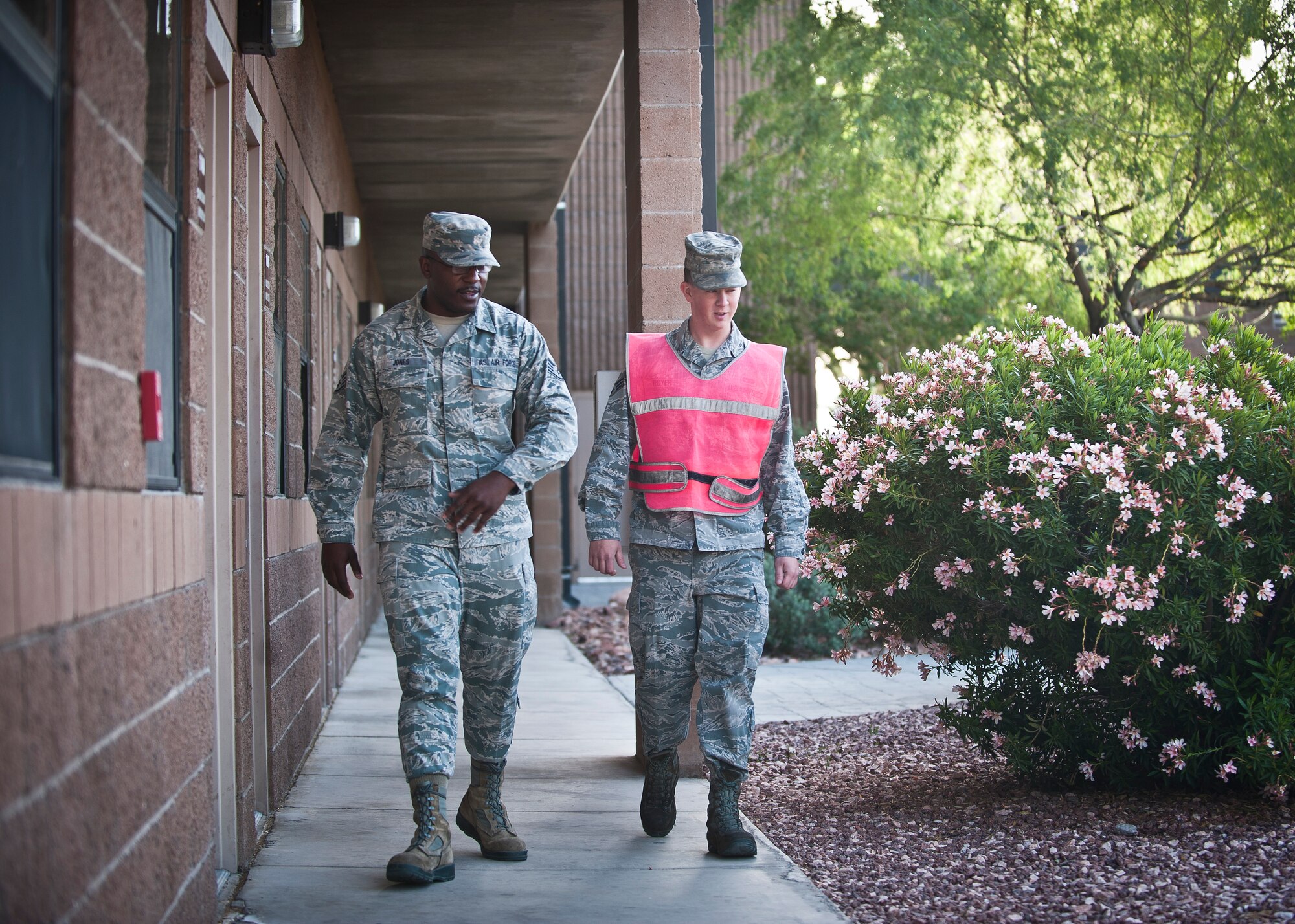 Staff Sgt. Council Jones, 99th Civil Engineer Squadron airman dormitory leader, mentors an Airman at Nellis Air Force Base, Nev., April 7, 2015. Jones, a security forces member by trade, passes on his experiences and wisdom gained from his career -- which almost ended prematurely because of an expletive-laced rant he made toward his squadron leadership -- to any Airman that will listen. (U.S. Air Force photo by Staff Sgt. Siuta B. Ika)