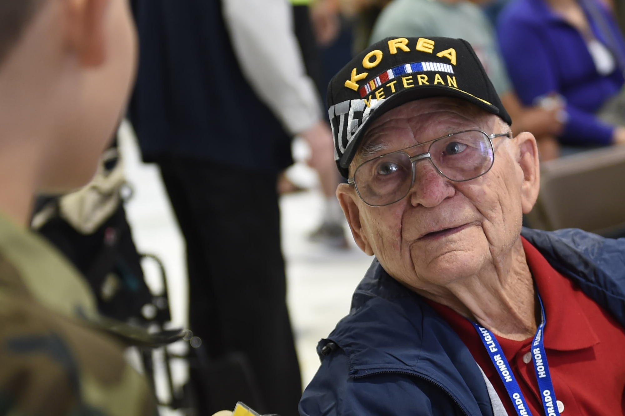 A Korea veteran speaks with two children before boarding a plane to May 3, 2015, at Denver International Airport in Denver. The veteran, along with 75 other World War II, Vietnam, Korea, terminally ill and Purple Heart recipient veterans, took a trip to Washington D.C. to visit military memorials. The overnight trip was hosted by the Honor Flight of Northern Colorado and is offered every year free of charge for the vets through donations from the public. (U.S. Air Force photo Airman 1st Class Samantha Meadors/Released)