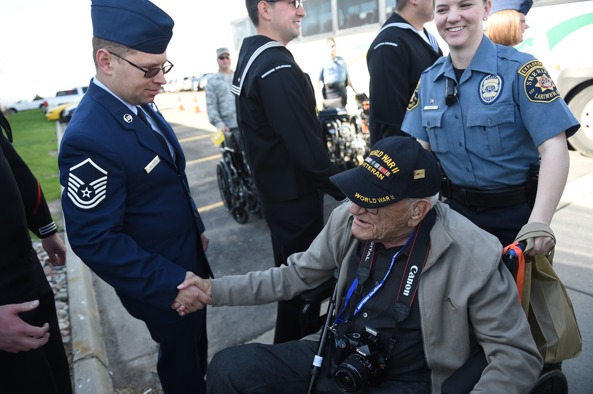 Military members currently serving greet World War II, Vietnam and  Korea veterans, along with terminally ill and Purple Heart recipient veterans as they get off a bus to board a plane May 3, 2015, at Denver International Airport in Denver. Hosted by the Honor Flight of Northern Colorado, the overnight trip to Washington D.C. gave veterans the chance to visit military memorials. The trip is offered every year free of charge for the vets through donations from the public. (U.S. Air Force photo Airman 1st Class Samantha Meadors/Released)