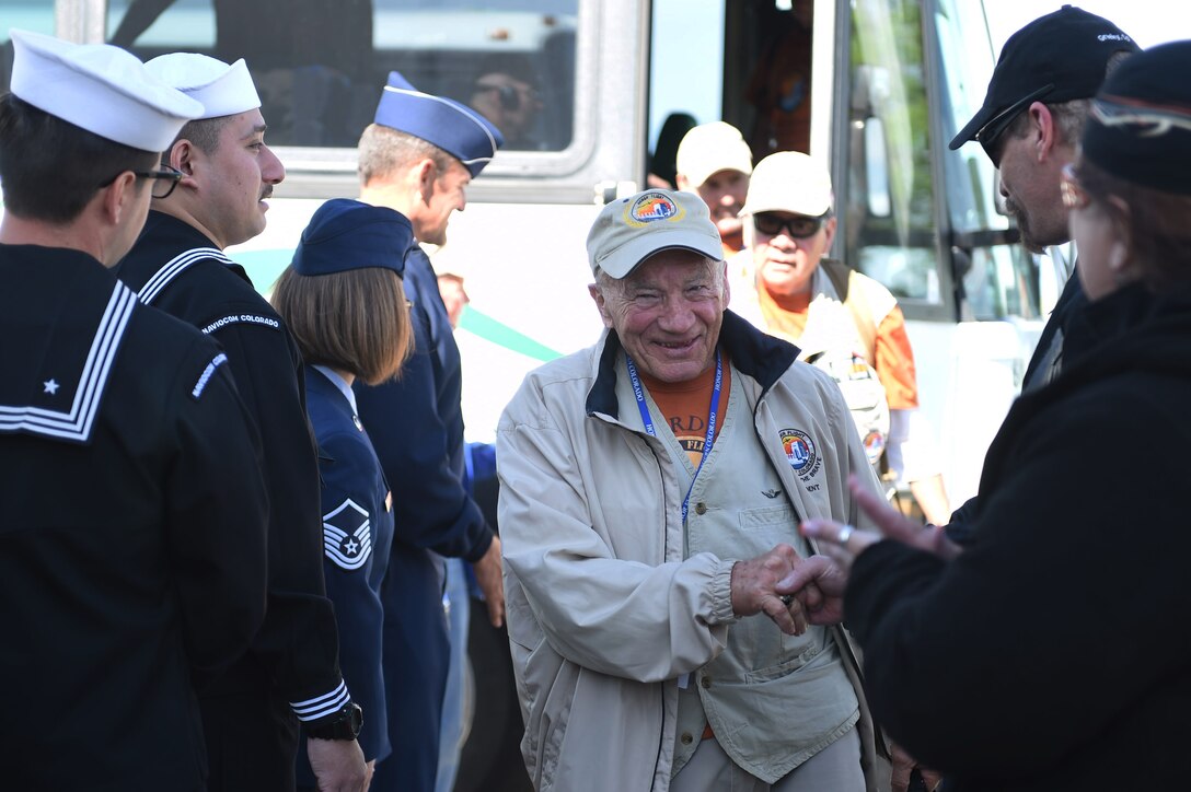 A veteran is greeted by military members currently serving as he steps off a bus to board a plane May 3, 2015, at Denver International Airport in Denver. The veteran, along with 75 other World War II, Vietnam and Korea veterans, along with terminally ill and Purple Heart recipient veterans, took a trip to Washington D.C. to visit military memorials. The overnight trip was hosted by the Honor Flight of Northern Colorado and is offered every year free of charge for the vets through donations from the public. (U.S. Air Force photo Airman 1st Class Samantha Meadors/Released)