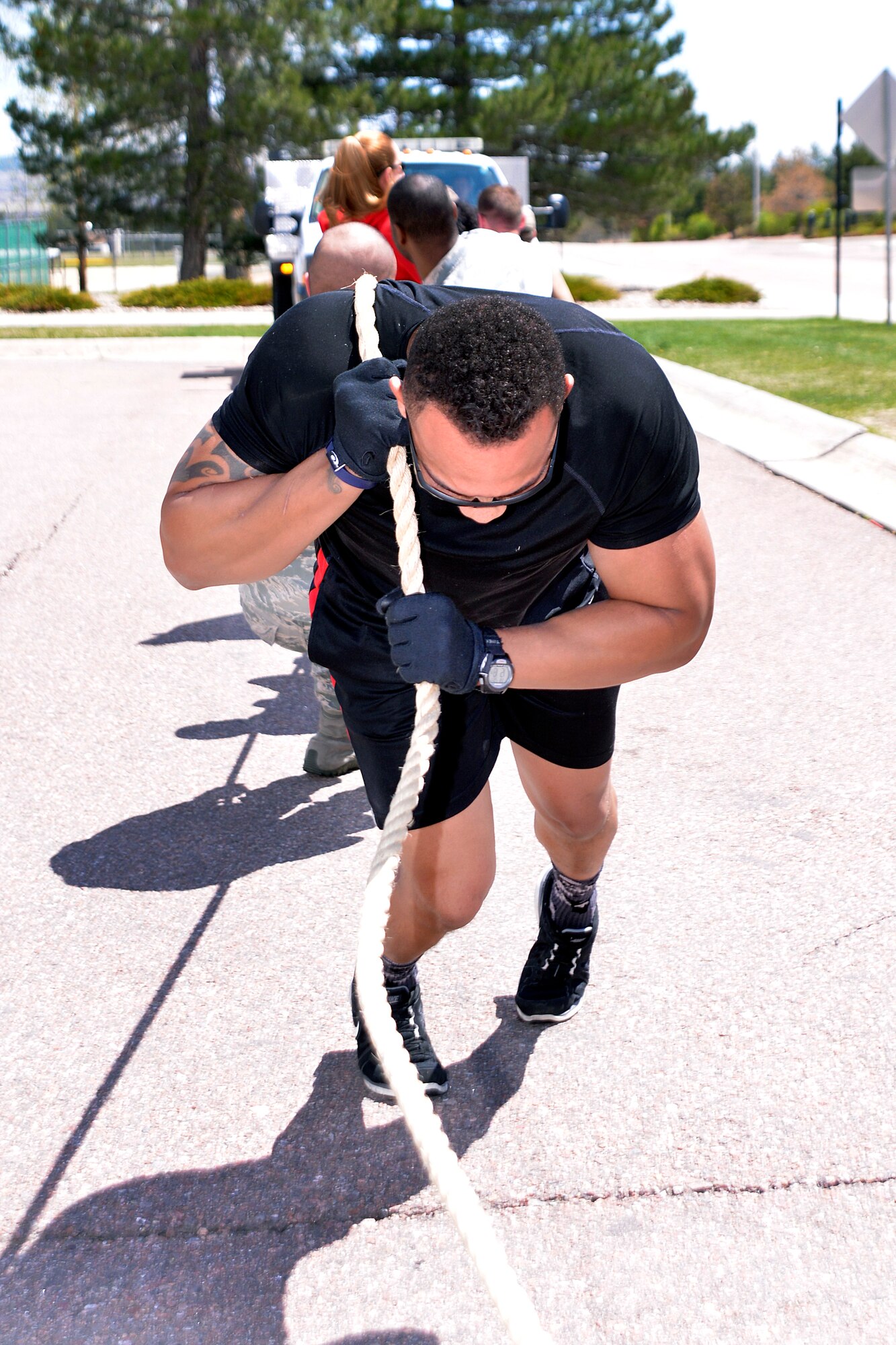 Airmen assigned to the U.S. Air Force Academy compete in a brush truck pull at the  Academy's Health and Fitness Expo here May 1. Airmen assigned to the 10th Surgical Operations Squadron took first place in the pull, pulling the truck across the finish line in just less than 16 seconds. The health fair included over 15 information booths, a three-mile run, and agility tests to promote comprehensive fitness. (Air Force photo/Jason Gutierrez)