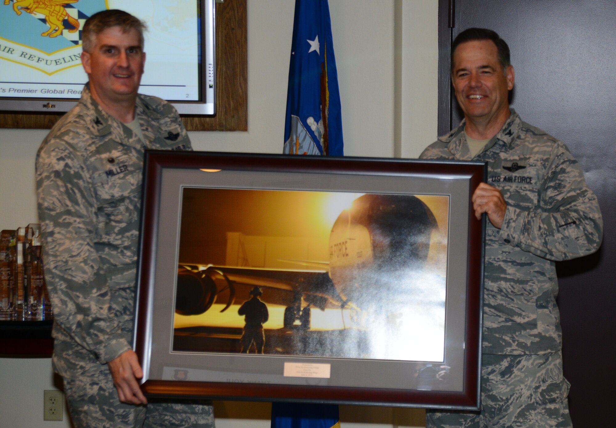 Col. Albert Miller, left, 22nd Air Refueling Wing commander, presents a token of appreciation to Col. Mark S. Larson, 931st Air Refueling Group commander, May 4, 2015, at McConnell Air Force Base, Kan. The 931st ARG graciously allowed the 22nd ARW headquarters to reside in Bldg. 850 during renovations to Bldg. 1. (U.S. Air Force photo by Airman 1st Class Christopher Thornbury)