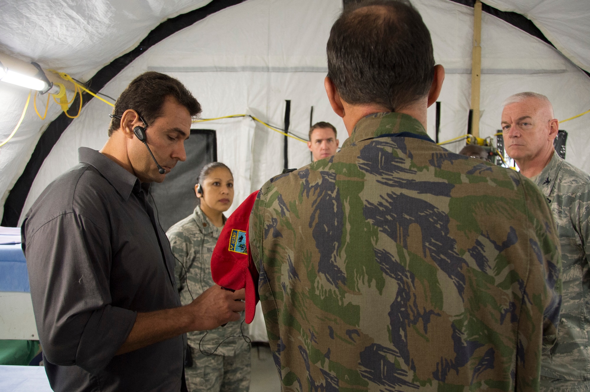 Members of Air Forces Southern speak with a member of the Brazilian air force during a brief exchange during an Expeditionary Medical Support training site visit on April 22, 2015, in Rio de Janeiro, Brazil. During the exchange the members shared insights about the current setup of the Brazilian EMEDS. (U.S. Air Force photo by Staff Sgt. Adam Grant/Released)
