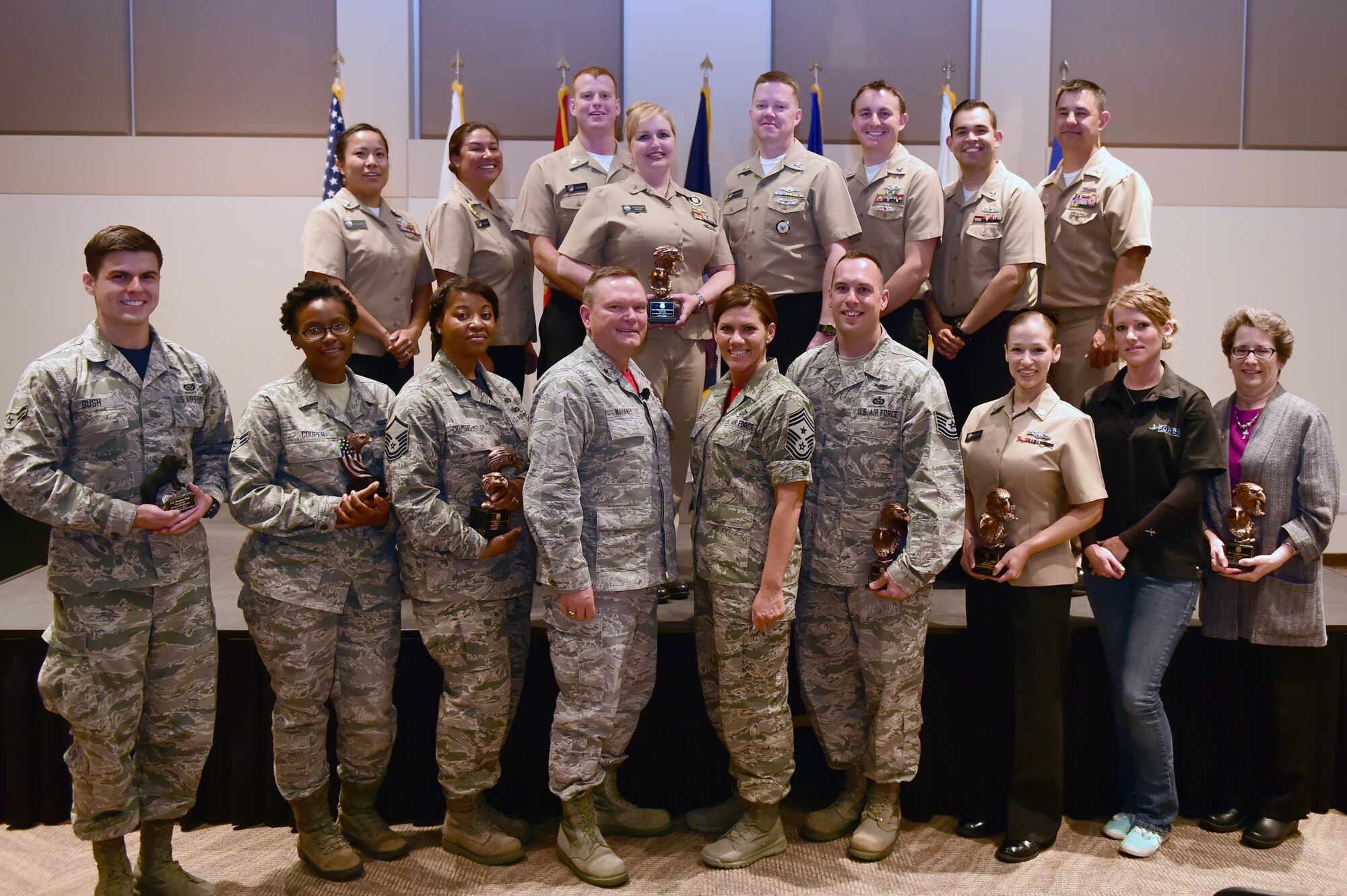 Team Buckley quarterly award winners stand alongside Brig. Gen. Samuel C. Mahaney, Air Reserve Personnel Center commander, and Chief Master Sgt. Ruthe Flores, ARPC command chief, on May 1, 2015, at the Leadership Development Center on Buckley Air Force Base, Colo. The award winners were chosen because of their hard work and dedication in their work centers. (U.S. Air Force photo by Airman 1st Class Luke W. Nowakowski/Released)
