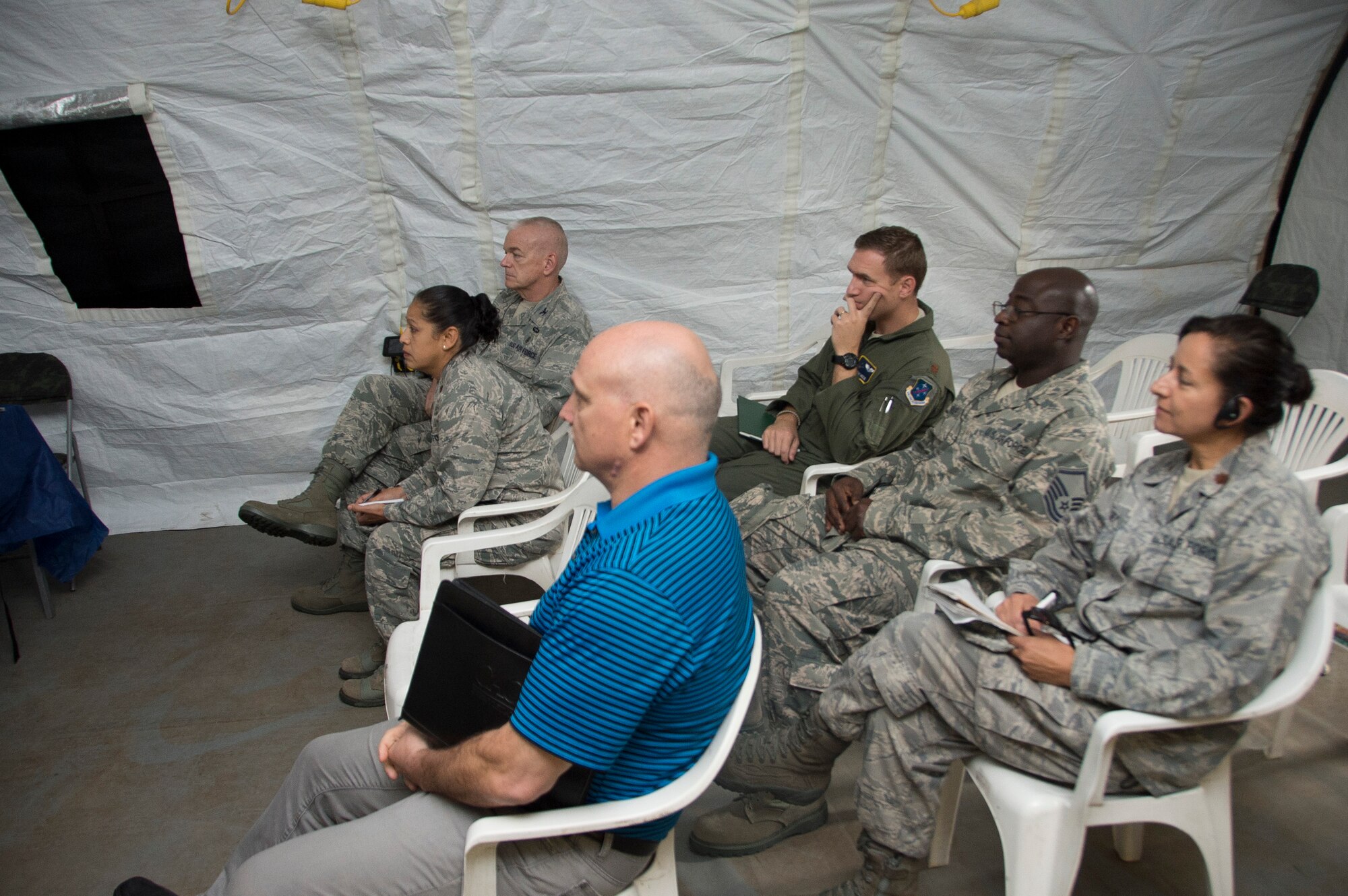 Members in support of Air Forces Southern receive a brief from members of the Brazilian air force during an Expeditionary Medical Support training site visit on April 22, 2015, in Rio de Janeiro, Brazil. During the site visit,  members of AFSOUTH assed the location chosen to place the EMEDS as well as checked to make sure all components of the EMEDS were properly installed. (U.S. Air Force photo by Staff Sgt. Adam Grant/Released)