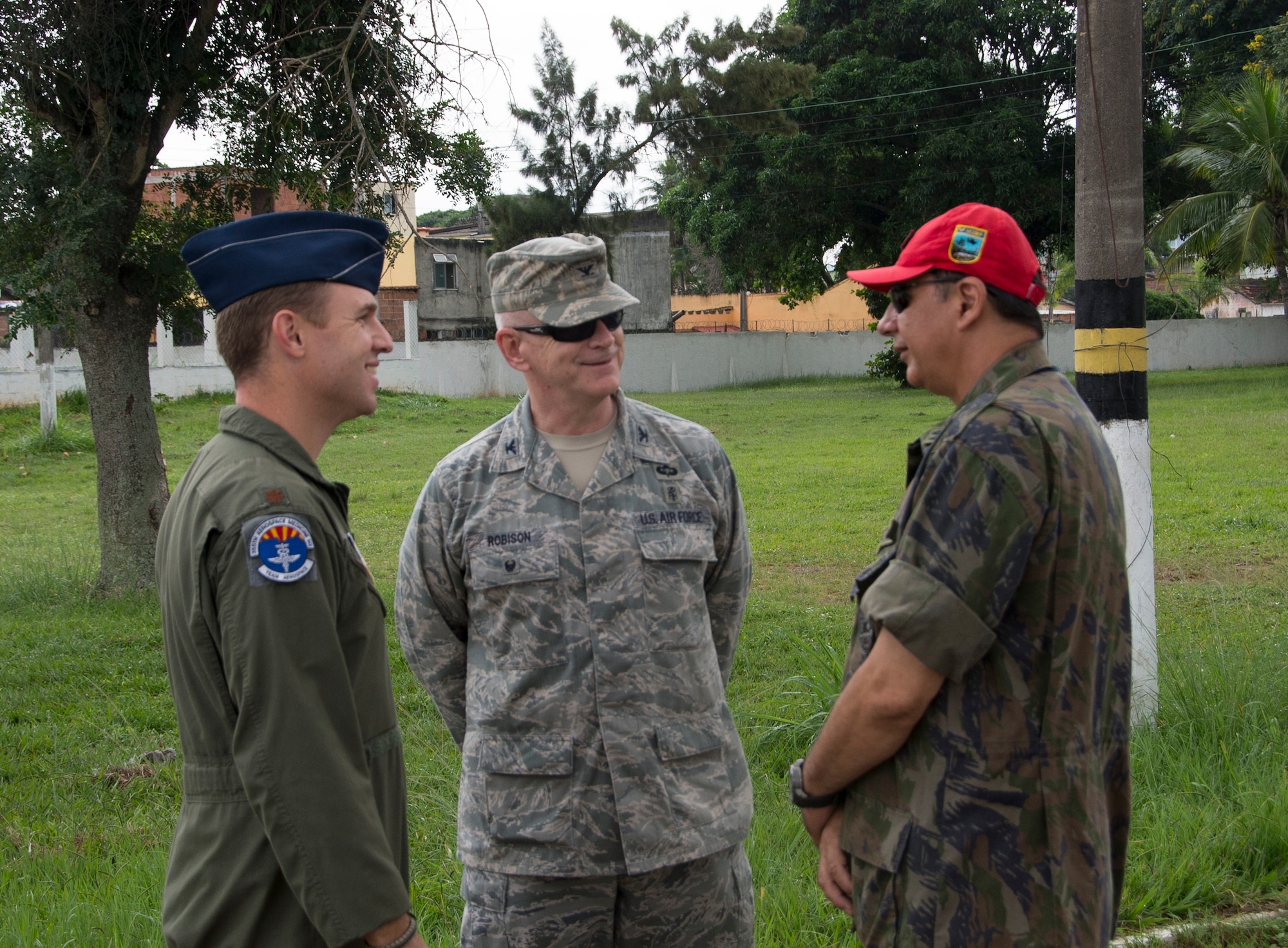 (Left) Maj. Maj. Brian Neese, 12th Air Force (Air Forces Southern) chief of international health specialists division, and Col. Elmo Robison, Headquarters Air Force chief of expeditionary operations and policy, speak with a member of the Brazilian air force during an Expeditionary Medical Support training site visit on April 22, 2015, in Rio de Janeiro, Brazil. During the site visit members of AFSOUTH were able to get an up close look at how their Brazilian counterparts set up the tents for EMEDS. (U.S. Air Force photo by Staff Sgt. Adam Grant/Released)