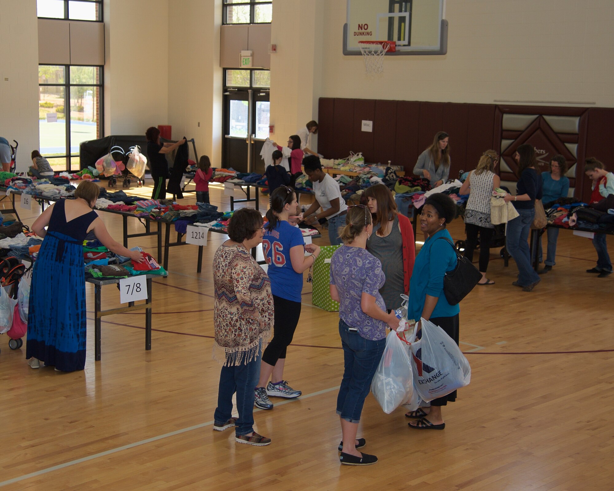 PETERSON AIR FORCE BASE, Colo. -- Volunteers and families fill the gym of the R.P Lee Youth Center on Peterson AFB during this year’s clothing drive May 2. The Peterson Schriever Cheyenne Mountain Spouses’ Club and a team of volunteers spent the month of April collecting and sorting gently used children’s clothes and other donations for the event, which were then distributed free to those attending the event. (U.S. Air Force photo by Staff Sgt. J. Aaron Breeden)