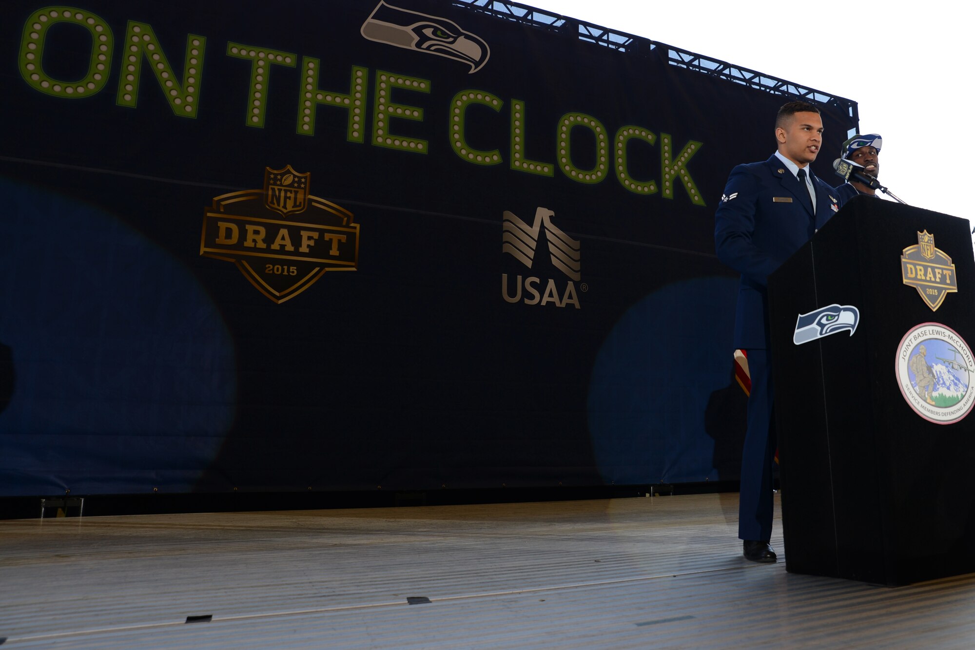 Airman 1st Class Michael Andrews, 10th Airlift Squadron loadmaster, announces one the Seattle Seahawks draft picks on Joint Base Lewis-McChord, Wash., May 2, 2015. Service members from each branch of service announced one of the Seahawks picks on the third day of the National Football League draft. (U.S. Air Force photo\ Staff Sgt. Tim Chacon)  