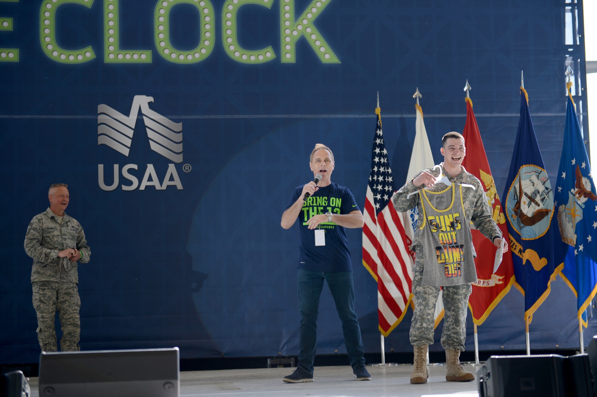 A soldier holds his prize after winning a game May 2, 2015, during the Seattle Seahawks draft day event at Joint Base Lewis-McChord, Wash. Attendees were able to meet some of the players and the mascots during the event and also watched performances by Blue Thunder, the Seahawks drumline band. (U.S. Air Force photo/Airman 1st Class Keoni Chavarria)