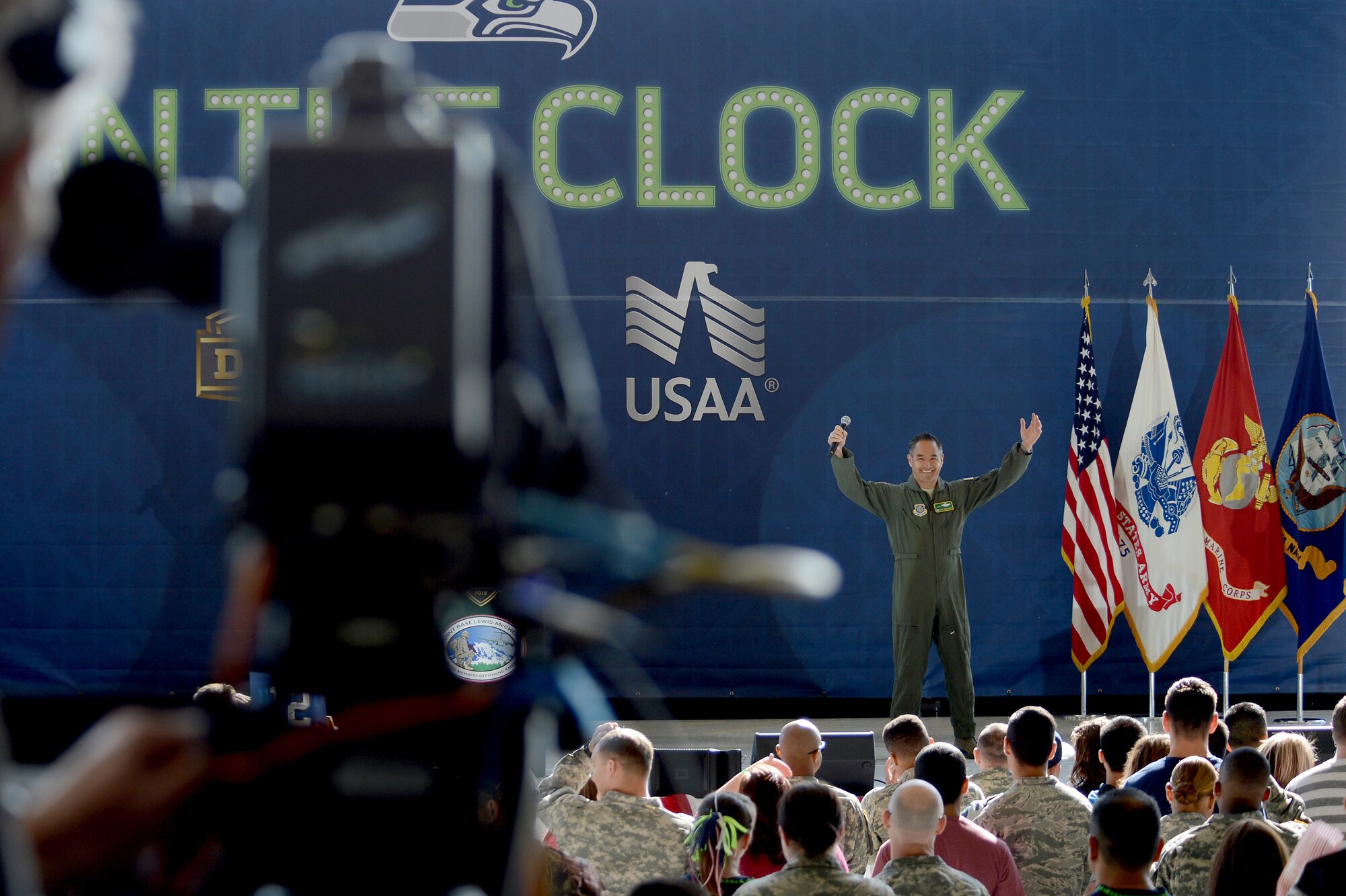 Col. David Kumashiro, 62nd Airlift Wing commander, talks to a crowd May 2, 2015, during the Seattle Seahawks draft day event at Joint Base Lewis-McChord, Wash. Throughout the day, the Seahawks made six picks which then were shown on the NFL Network channel or through social media platforms. (U.S. Air Force photo/Airman 1st Class Keoni Chavarria)