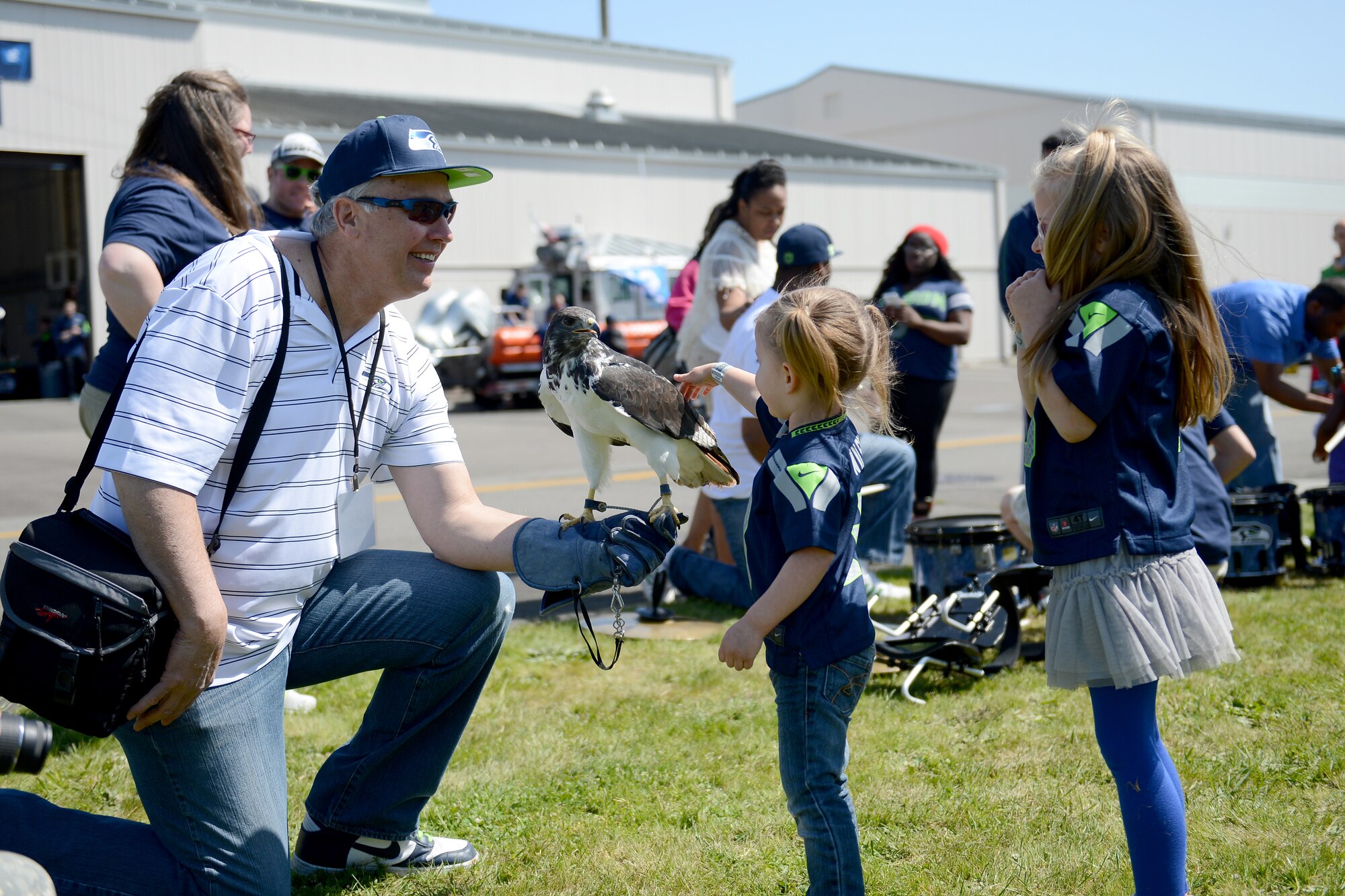 Children pet Tamia, the official hawk of the Seattle Seahawks May 2, 2015, during the Seattle Seahawks draft day event at Joint Base Lewis-McChord, Wash. During the event, attendees were able to play free games such as shooting arrows at floating targets, and also received free drinks and food. (U.S. Air Force photo/Airman 1st Class Keoni Chavarria)