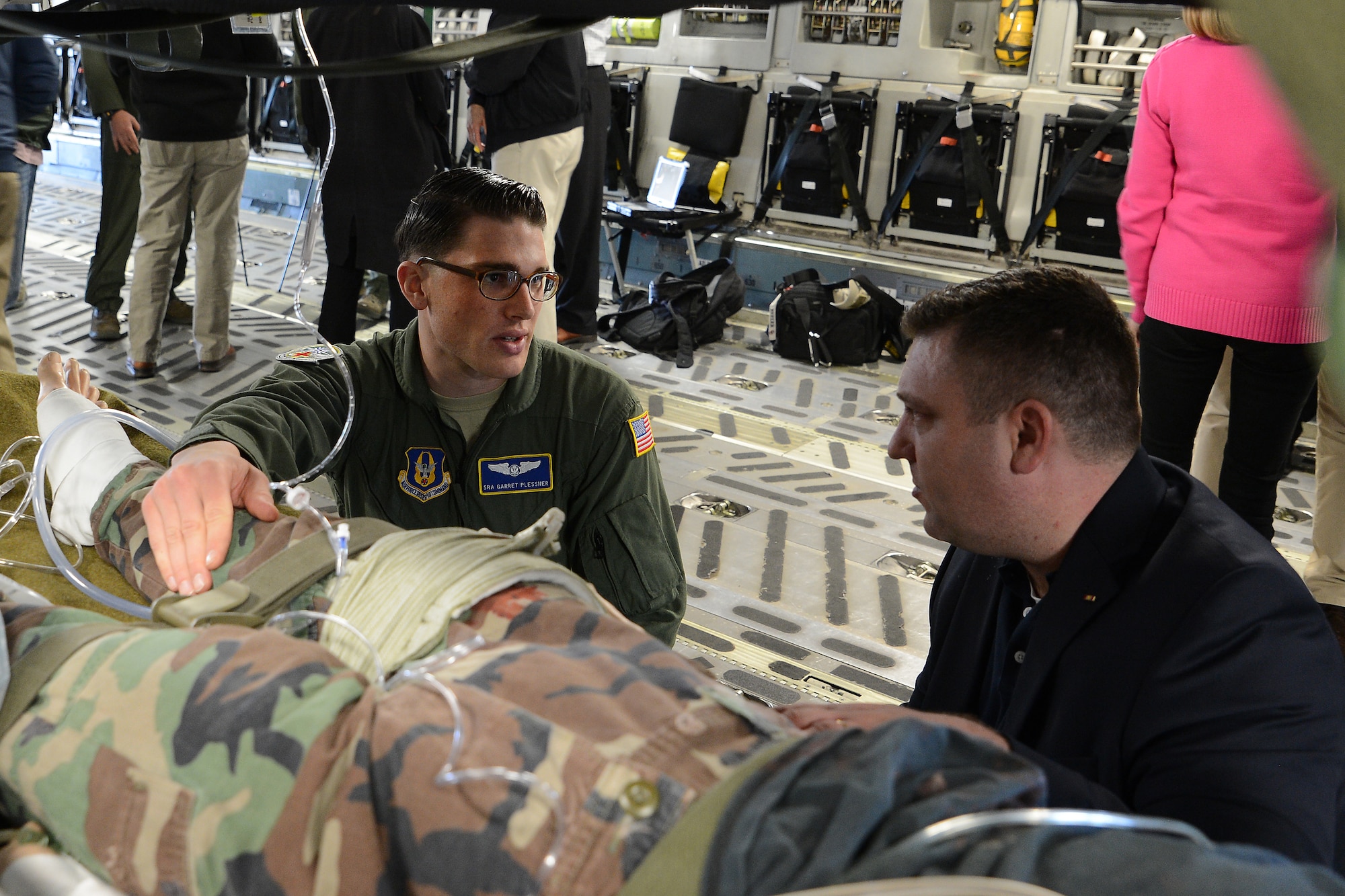 Senior Airman Garret Plessner, 446th Airlift Wing in flight medical technician, briefs members of the Seattle 4 Rotary April 30, 2015, at Joint Base Lewis-McChord, Wash., on aeromedical evacuation operations. The rotary club members toured the C-17 learning about the aircraft and the missions it is utilized in. (U.S. Air Force photo\Staff Sgt. Tim Chacon)