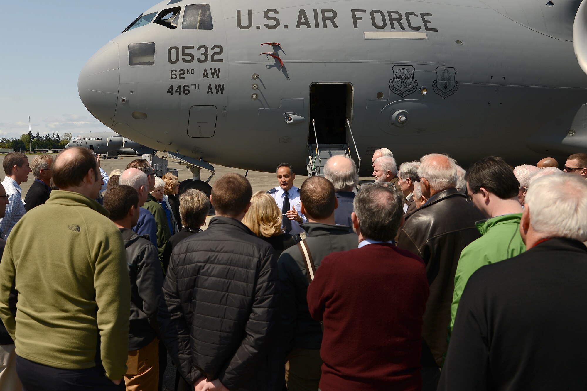 Col. David Kumashiro, 62nd Airlift Wing commander, talks with members of the Seattle 4 Rotary Club prior to touring a C-17 Globemaster III April 30, 2015, at Joint Base Lewis-McChord, Wash. The rotary club members toured the C-17 and learned about the various missions the 62nd and 446th Airlift Wings perform. (U.S. Air Force photo\Staff Sgt. Tim Chacon)
