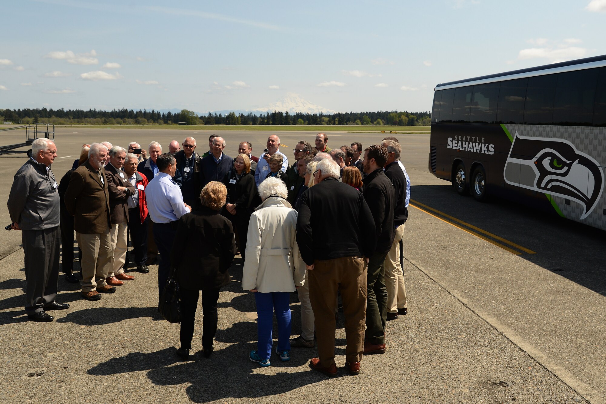 Col. David Kumashiro, 62nd Airlift Wing commander, talks with members of the Seattle 4 Rotary Club prior to touring a C-17 Globemaster III April 30, 2015, at Joint Base Lewis-McChord, Wash. The rotary club members toured the C-17 and learned about the various missions the 62nd and 446th Airlift Wings perform. (U.S. Air Force photo\Staff Sgt. Tim Chacon)