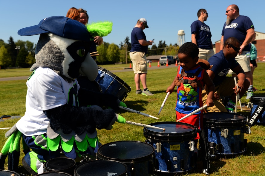 Boom, the Seattle Seahawks mascot, plays drums with event goers at the Seahawks draft day event on Joint Base Lewis-McChord, Wash., May 2, 2015. The event featured service members announcing Seahawks draft picks and several forms of entertainment such as armchair quarterback, shuffle board, pool tables, a football toss and kick game, photos with the 2013 Lombardi and 2014 National Football Conference championship trophies, video gaming, autographs from eight different Seahawk players, free food and drink and numerous military statics from across the Sound. (U.S. Air Force photo\ Staff Sgt. Tim Chacon) 