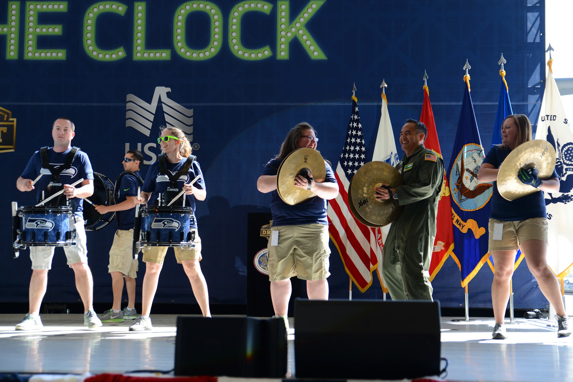 Col. David Kumashiro, 62nd Airlift Wing commander plays the cymbals with the Seattle Seahawks drumline band Blue Thunder on Joint Base Lewis-McChord, Wash., May 2, 2015. Blue Thunder was one of many forms of entertainment at the Seahawks draft day event on JBLM.  (U.S. Air Force photo\ Staff Sgt. Tim Chacon) 
