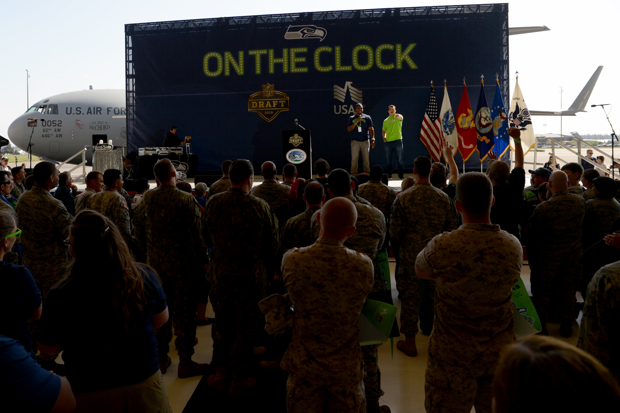 Greg Suggs, Seattle Seahawks defensive end (left), and Brock Coyle, Seahawks linebacker, talk to the crowd during the Seahawks draft day event on Joint Base Lewi-McChord, Wash., May 2, 2015. The event took place on the third day of the 2015 NFL draft and featured several service members from the Air Force, Army, Marines, Navy, and Coast Guard announcing the Seahawks draft picks. (U.S. Air Force photo\ Staff Sgt. Tim Chacon) 
