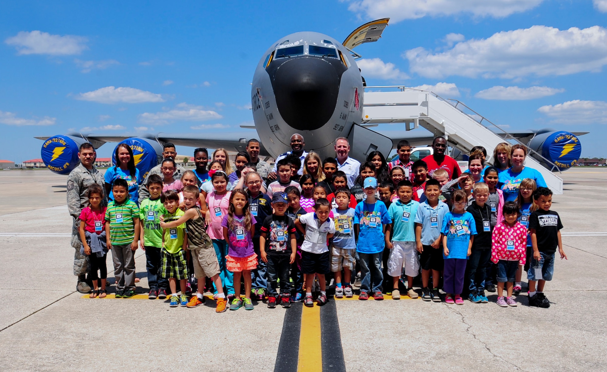 Approximately 50 Gibsonton Elementary School students, along with teachers and 6th Maintenance Group leadership pose for a group photo in front of a KC-135 Stratotanker May 1, 2015 at MacDill Air Force Base, Fla. Each student received a security line badge and was presented an Honorary Crew Chief Certificate from Col. Reginald Godbolt, 6th MXG commander, and Chief Master Sgt. Douglas Earle, 6th MXG superintendent, during the awards ceremony at the end of the day. (U.S. Air Force photo by Senior Airman Jenay Randolph/Released) 