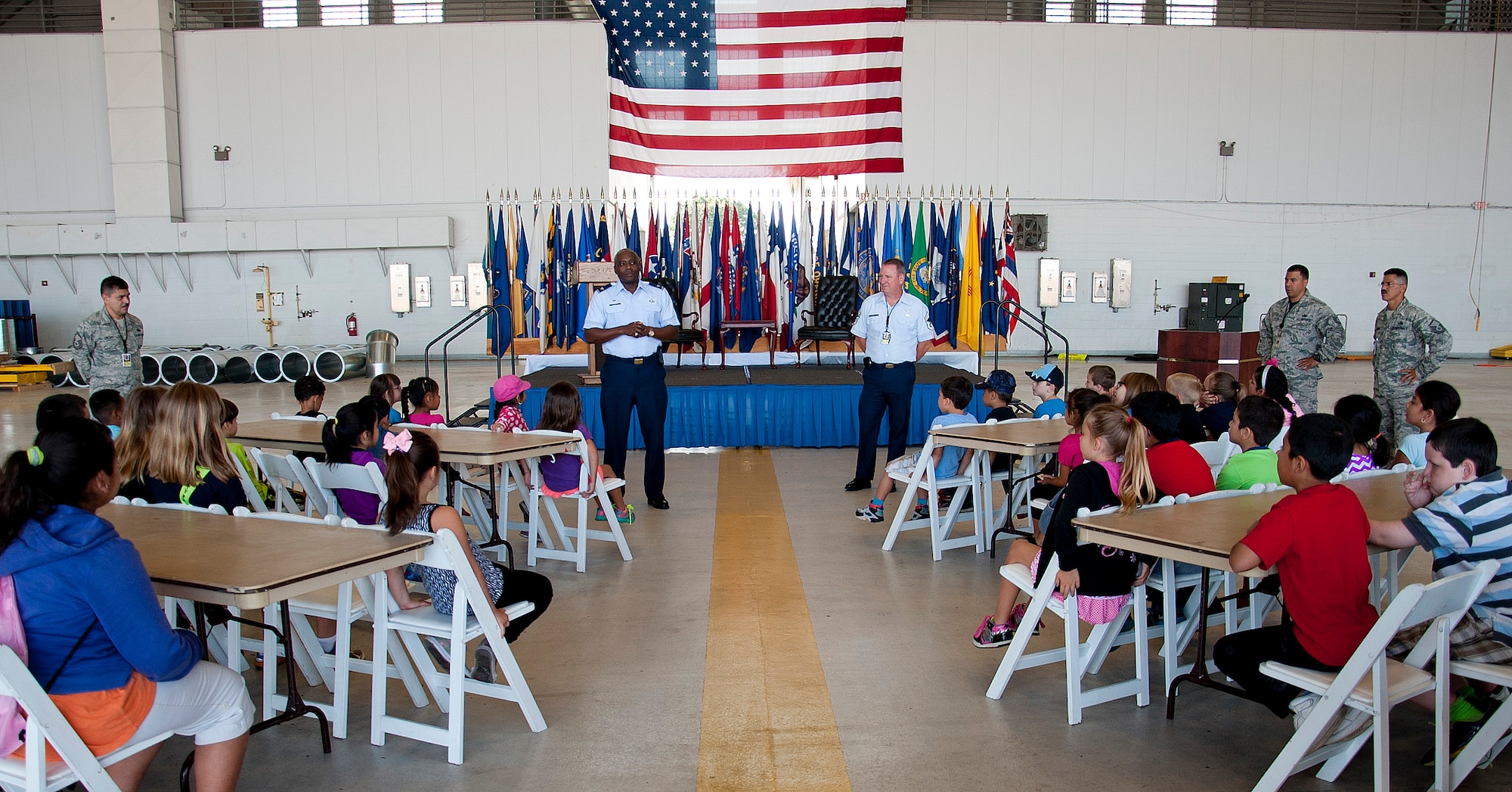 Col. Reginald Godbolt, 6th Maintenance Group commander, and Chief Master Sgt. Douglas Earle, 6th MXG superintendent, give opening remarks and welcome the Rising Stars from Gibsonton Elementary School to MacDill Air Force Base, Fla., May 1, 2015. The Rising Star Program is a partnership between The Mosaic Company, Gibsonton Elementary School and MacDill AFB, that has been in place for the past 15 years. (U.S. Air Force photo by Senior Airman Jenay Randolph/Released) 