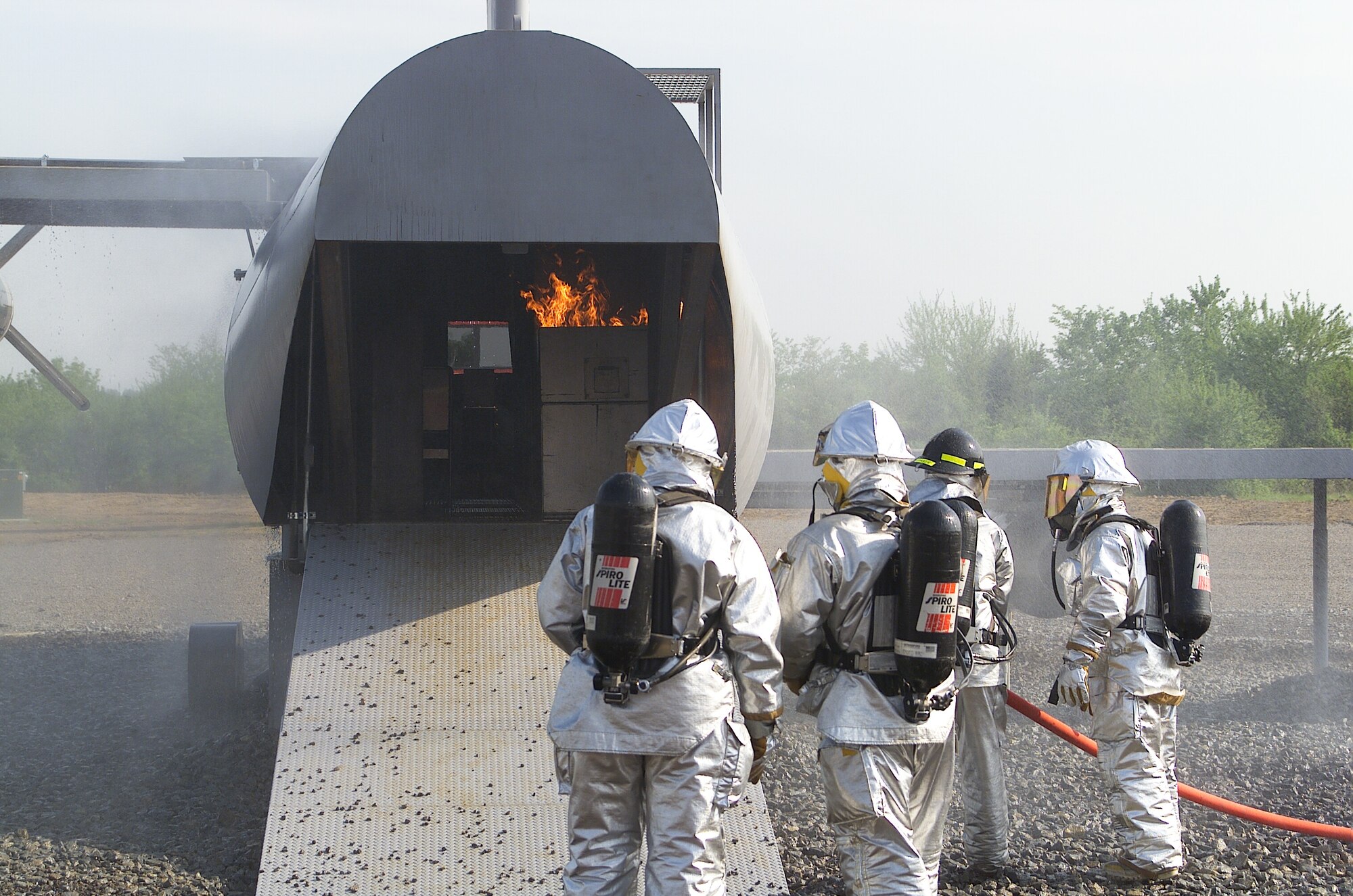 Former 1st Lady of Arkansas Janet Huckabee, left, works with a group of 188th Wing firefighters during the 188th Civil Engineer Squadron Urban Search and Rescue Site's opening ceremony at Ebbing Air National Guard Base, Fort Smith, Ark., May 2, 2002. (U.S. Air National Guard photo by Senior Master Sgt. Dennis Brambl/released)