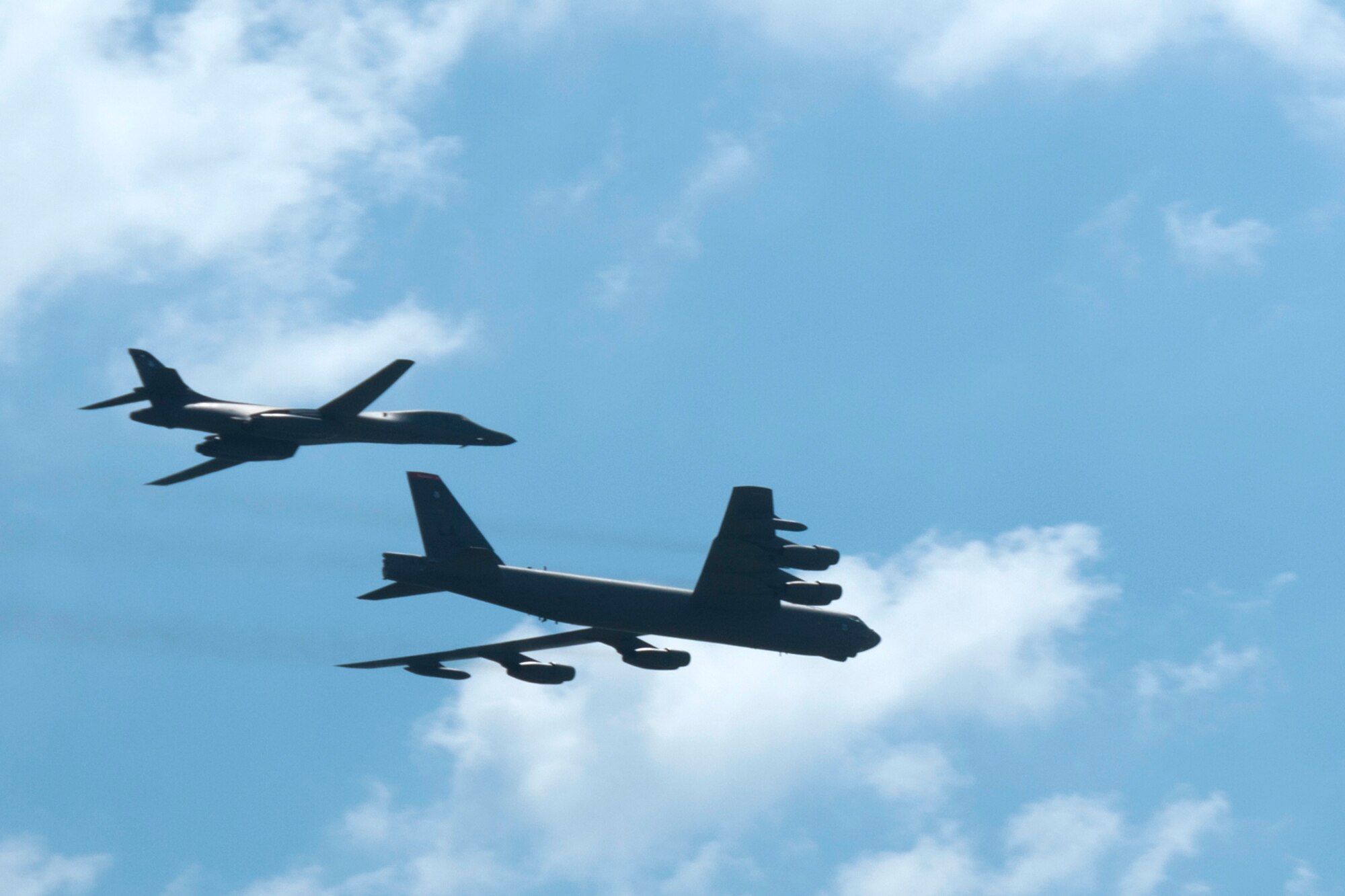 A B-1 Lancer and a B-52 Stratofortress fly overhead to open the Defenders of Liberty Air Show at Barksdale Air Force Base, La., May 2, 2015.  Several thousand people attended the air show which featured aircraft from throughout the U.S. Air Force inventory. (U.S. Air Force photo by Tech. Sgt. Ted Daigle/released)