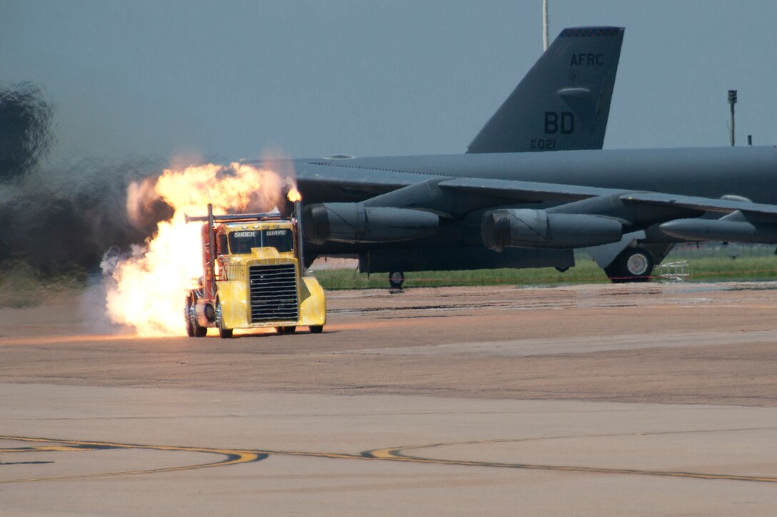 Shockwave the Jet Truck spews flames as it thunders past a group of parked B-52 Stratofortresses at Barksdale Air Force Base, La., May 2, 2015.   A unique display at the Defenders of Liberty Air Show Show, the truck can reach speeds in excess of 300 miles per hour. (U.S. Air Force photo by Tech. Sgt. Ted Daigle/Released)