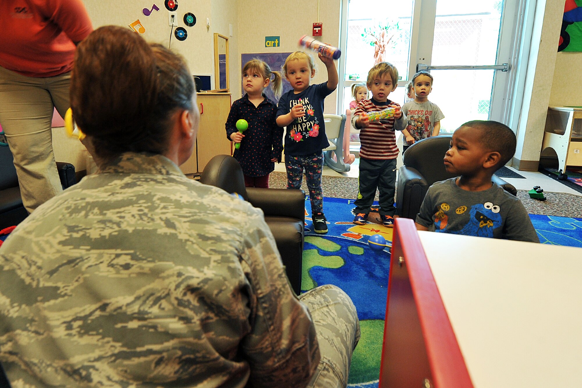 In recognition of the military child, U.S. Air Force Technical Sgt. Rebecca Packhard, vocalist with the U.S. Air Force Heartland of America Band, performs various songs to a crowd of children at Offutt’s child develop center on Offutt AFB, Neb., April 27. The Heartland of America Band has a rich history of inspiring hearts and minds, building and sustaining American patriotism, and enhancing esprit de corps in the U.S. Air Force.  (U.S. Air Force photo by Charles Haymond/Released)