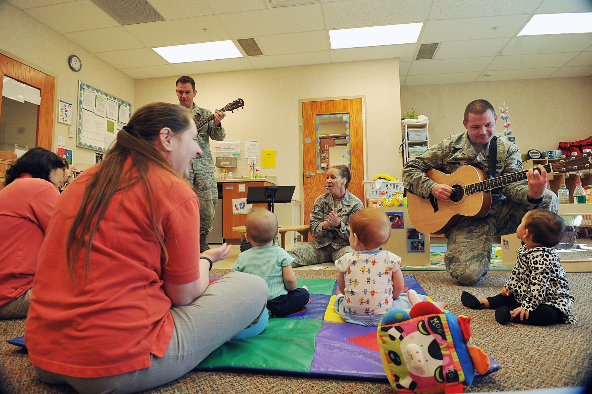 In recognition of the military child, U.S. Air Force Technical Sgt. Rebecca Packhard and other members of the USAF Heartland of America Band sing to a crowd of infants and toddlers at Offutt’s children development center on Offutt AFB, Neb., April 27. The Heartland of America Band is a group of Air Force professional musicians whose backgrounds include advanced degrees in music performance and whose broad mastery of musical styles range from classic to contemporary, jazz to country, and pop to rock. (U.S. Air Force photo by Charles Haymond/Released)