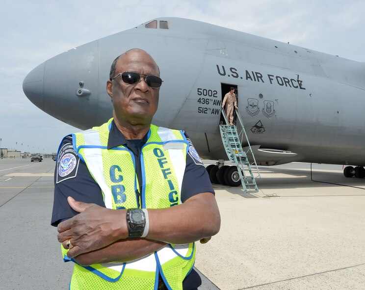 Leroy Jubilee, U.S. Customs and Border Protection agricultural specialist, stands near the nose of a C-5M Super Galaxy of the 436th Airlift Wing after performing his final agricultural inspection of an aircraft during his last day of work for CBP April 30, 2015, at Dover Air Force Base, Del. Jubilee is retiring with 50 years of government service and is a senior agricultural expert for CBP on the East Coast. (U.S. Air Force photo/Greg L. Davis)